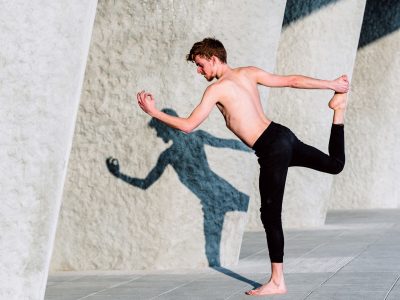 Natarajasana yoga, the posture of the Lord of the Dance practiced by a young barefoot men.